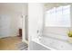 Bright bathroom with a jetted tub, privacy window, and separate shower at 1223 Creek Stone Way, Hanahan, SC 29410