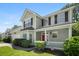 Charming two-story home features a welcoming front porch, red door, and manicured landscaping at 1223 Creek Stone Way, Hanahan, SC 29410
