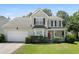 Charming two-story home with a manicured lawn, attached garage, and inviting red front door at 1223 Creek Stone Way, Hanahan, SC 29410