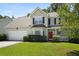 Inviting two-story home featuring an attached garage and well-maintained landscaping at 1223 Creek Stone Way, Hanahan, SC 29410