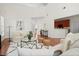 Sun-drenched living room with hardwood floors, neutral décor, and a soaring ceiling at 1223 Creek Stone Way, Hanahan, SC 29410