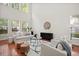 Bright, open living room with soaring ceilings, hardwood floors, and multiple windows at 1223 Creek Stone Way, Hanahan, SC 29410