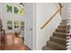 Open-concept living room featuring hardwood floors, and a staircase at 1223 Creek Stone Way, Hanahan, SC 29410