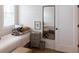 Cozy bedroom featuring a tall mirror, side table, and inviting decor elements at 126-C Jungle Rd, Edisto Beach, SC 29438