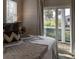 Bedroom features a bed and an outdoor view through a sliding glass door, letting in natural light at 126-C Jungle Rd, Edisto Beach, SC 29438