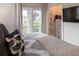 Bright bedroom with a closet, TV, and large windows offering outdoor views at 126-C Jungle Rd, Edisto Beach, SC 29438