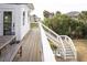Relaxing deck area with outdoor furniture, providing a serene spot to unwind and enjoy the view at 126-C Jungle Rd, Edisto Beach, SC 29438