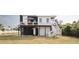 Stylish home with a charming exterior, featuring an outdoor deck and well-manicured lawn at 126-C Jungle Rd, Edisto Beach, SC 29438