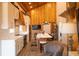 Bright kitchen with white cabinets, black appliances, and wood paneled accent walls at 126-C Jungle Rd, Edisto Beach, SC 29438