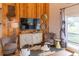 Cozy living room featuring wood paneled walls, comfortable seating, and stylish decor at 126-C Jungle Rd, Edisto Beach, SC 29438