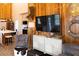 Living room features wood paneled walls, comfortable seating, and neutral decor at 126-C Jungle Rd, Edisto Beach, SC 29438
