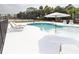 Beautiful pool area with lounge chairs and shade umbrella to relax and enjoy the backyard at 126-C Jungle Rd, Edisto Beach, SC 29438