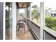 Cozy screened-in porch with comfortable seating and views of lush greenery, perfect for relaxation at 126-C Jungle Rd, Edisto Beach, SC 29438