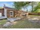 Brick home with a wooden deck, trellis, and a spacious, partially shaded backyard at 1383 W Lenevar Dr, Charleston, SC 29407