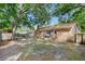 Spacious backyard with brick home, wooden fence, and mature trees, offering privacy at 1383 W Lenevar Dr, Charleston, SC 29407