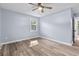 Bedroom with wood-look floors, neutral paint, and window with natural light at 1383 W Lenevar Dr, Charleston, SC 29407