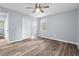 Neutral bedroom with wood-look floors, closet, window, and light paint at 1383 W Lenevar Dr, Charleston, SC 29407