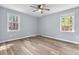Neutral bedroom with wood-look floors, ceiling fan, closet, and natural light at 1383 W Lenevar Dr, Charleston, SC 29407
