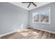 Bedroom with wood-look floors, neutral paint, and window with natural light at 1383 W Lenevar Dr, Charleston, SC 29407