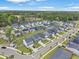 An aerial view shows new homes nestled among established trees and landscaping under a blue sky at 1441 Arabella St, Charleston, SC 29414