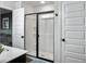 Contemporary bathroom showcasing a glass-enclosed shower and an open doorway to the main bedroom at 1441 Arabella St, Charleston, SC 29414
