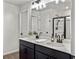 Modern bathroom featuring a double vanity with sleek black cabinets and a spacious shower with glass enclosure at 1441 Arabella St, Charleston, SC 29414
