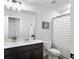 Well-lit bathroom with a double vanity, toilet, and a shower with a decorative shower curtain at 1441 Arabella St, Charleston, SC 29414