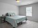 Simple bedroom with a queen bed, side table, and a sunlit window for a calm and restful space at 1441 Arabella St, Charleston, SC 29414