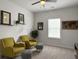 Bright bedroom with plush carpet, ceiling fan, two chairs, and natural light from a large window at 1441 Arabella St, Charleston, SC 29414
