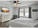 Primary bedroom featuring hardwood floors, dresser, TV, and window with black-out curtains at 1441 Arabella St, Charleston, SC 29414
