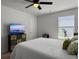 Cozy bedroom with a queen-size bed, decorative pillows, and a TV for relaxed viewing at 1441 Arabella St, Charleston, SC 29414