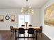 Elegant dining room with modern lighting, stylish decor, and a view of the backyard through sliding doors at 1441 Arabella St, Charleston, SC 29414