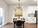 Modern dining area with sleek lighting, a wooden table, and a painting, perfect for Gathering meals at 1441 Arabella St, Charleston, SC 29414