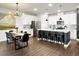 Modern kitchen with stainless steel appliances, island with bar seating, and stylish lighting fixture at 1441 Arabella St, Charleston, SC 29414