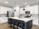 Bright kitchen showcasing a large island with seating, stainless steel appliances, and modern lighting at 1441 Arabella St, Charleston, SC 29414