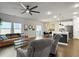 Open-concept living room features hardwood floors, ceiling fan, dining area, island kitchen with stainless steel appliances at 1441 Arabella St, Charleston, SC 29414