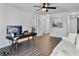Home office featuring hardwood floors, a ceiling fan, couch, and a modern desk setup at 1441 Arabella St, Charleston, SC 29414