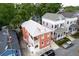 Aerial shot showcasing several houses, a metal roof, and residential neighborhood on a sunny day at 15 Dewey St, Charleston, SC 29403