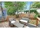Private back deck with outdoor seating area surrounded by lush greenery at 15 Dewey St, Charleston, SC 29403