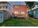 Backyard with wooden deck, green lawn, golf cart, and privacy fence at dusk at 15 Dewey St, Charleston, SC 29403
