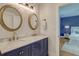 Elegant bathroom featuring double sinks, marble countertop, and classic gold fixtures in a light and bright space at 15 Dewey St, Charleston, SC 29403