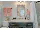 Well-lit bathroom featuring a marble countertop, a modern vanity, and decorative towels and fixtures at 15 Dewey St, Charleston, SC 29403