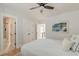 Well-lit bedroom featuring hardwood floors, a ceiling fan, a large closet, and an ensuite bathroom at 15 Dewey St, Charleston, SC 29403