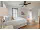 Bright bedroom with hardwood floors, shutters, a ceiling fan, and a comfortable bed with white linens at 15 Dewey St, Charleston, SC 29403