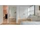 Comfortable bedroom featuring a large mirror, hardwood floors, a shuttered window, and access to an ensuite bathroom at 15 Dewey St, Charleston, SC 29403