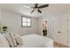 Cozy bedroom with hardwood floors, a ceiling fan, natural light, and a view into the ensuite bathroom at 15 Dewey St, Charleston, SC 29403