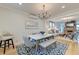 Elegant dining room with modern chandelier and view into the cozy living room at 15 Dewey St, Charleston, SC 29403