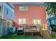 Rear exterior view of a two-story home with wood deck, wooden fence, golf cart, and AC unit at 15 Dewey St, Charleston, SC 29403