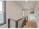 Hallway with hardwood floors, modern railings, natural light, and staircase at 15 Dewey St, Charleston, SC 29403