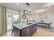 Modern kitchen with an island featuring sink, seating, and a view into the dining area at 15 Dewey St, Charleston, SC 29403